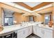 Double vanity bathroom with large mirrors and beige walls at 8227 Rhanbuoy Rd, Spring Hill, FL 34606