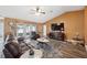 Living room with leather furniture, wood floors, and large TV at 8227 Rhanbuoy Rd, Spring Hill, FL 34606