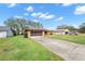Single-story house with driveway and neighborhood view at 8227 Rhanbuoy Rd, Spring Hill, FL 34606