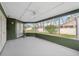 Screened porch with ceiling fan and backyard access at 8227 Rhanbuoy Rd, Spring Hill, FL 34606