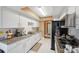 Kitchen boasts granite countertops and white cabinets at 8227 Rhanbuoy Rd, Spring Hill, FL 34606