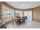 Bright breakfast nook with wood table and chairs, and access to backyard at 8227 Rhanbuoy Rd, Spring Hill, FL 34606