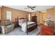 Spacious bedroom with a post bed and ceiling fan at 8227 Rhanbuoy Rd, Spring Hill, FL 34606