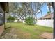 Large backyard with mature trees and a white fence at 8227 Rhanbuoy Rd, Spring Hill, FL 34606
