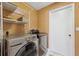 Laundry room with washer, dryer, and shelving at 8227 Rhanbuoy Rd, Spring Hill, FL 34606