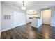 Living room with dark wood floors and kitchen bar at 4138 Central Sarasota Pkwy # 1524, Sarasota, FL 34238