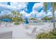 Inviting pool deck with lounge chairs, tables and umbrellas at 8320 112Th St # 104, Seminole, FL 33772