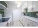Bright kitchen featuring white cabinetry and a green tile backsplash at 8320 112Th St # 104, Seminole, FL 33772