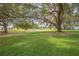 Expansive lawn with mature oak trees and a tranquil waterway at 8320 112Th St # 104, Seminole, FL 33772