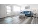 Living room with blue sofa and gray wood flooring at 8320 112Th St # 104, Seminole, FL 33772