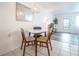 Dining area with white table and mid-century chairs at 8320 112Th St # 104, Seminole, FL 33772