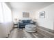 Living room with blue sofa and gray wood flooring at 8320 112Th St # 104, Seminole, FL 33772