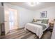 Bright bedroom with wood-look floors and an ensuite bathroom at 8320 112Th St # 104, Seminole, FL 33772