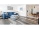 Living room with blue sofa and gray wood flooring at 8320 112Th St # 104, Seminole, FL 33772
