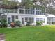 View of the condo building and surrounding landscape at 8320 112Th St # 104, Seminole, FL 33772