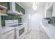 Updated kitchen with white cabinets, green tile backsplash, and modern appliances at 8320 112Th St # 104, Seminole, FL 33772