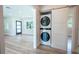 Modern laundry room with stacked washer and dryer, and barn door at 1227 Arden Ave, Clearwater, FL 33755