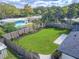 Landscaped backyard with large lawn and patio area at 1227 Arden Ave, Clearwater, FL 33755