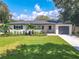Newly renovated home with a landscaped lawn and modern finishes at 1227 Arden Ave, Clearwater, FL 33755