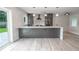 Modern kitchen island with white quartz countertop and gray cabinets at 1227 Arden Ave, Clearwater, FL 33755