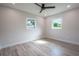Spacious bedroom with ceiling fan and large windows at 1227 Arden Ave, Clearwater, FL 33755