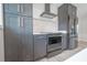 Modern kitchen with stainless steel appliances and dark cabinets at 1227 Arden Ave, Clearwater, FL 33755