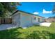 Newly renovated home's backyard, showcasing a patio and grassy area at 1227 Arden Ave, Clearwater, FL 33755