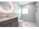 Modern bathroom with updated vanity, large mirror and walk-in shower at 1227 Arden Ave, Clearwater, FL 33755