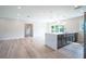 Open concept kitchen with island, white quartz countertops, and gray cabinets at 1227 Arden Ave, Clearwater, FL 33755