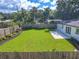 Spacious backyard with lush lawn, patio, and wooden fence, ideal for outdoor entertaining at 1227 Arden Ave, Clearwater, FL 33755