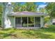 View of the home's back, featuring sliding glass doors at 6775 Timberland Ln, Sarasota, FL 34241