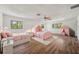 Bedroom with two twin beds, a playful canopy, and hardwood floors at 6775 Timberland Ln, Sarasota, FL 34241