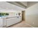 Modern wet bar with white cabinetry and a pool view at 6775 Timberland Ln, Sarasota, FL 34241