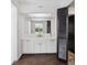 White bathroom vanity with a large mirror and tile floors at 6775 Timberland Ln, Sarasota, FL 34241