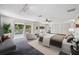 Main bedroom with a large bed, sitting area and access to a balcony at 6775 Timberland Ln, Sarasota, FL 34241
