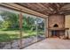 Bonus room with wood-beamed ceiling, brick pizza oven and backyard access at 6775 Timberland Ln, Sarasota, FL 34241