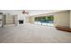 Spacious living room with fireplace, built-in shelves, and pool access at 6775 Timberland Ln, Sarasota, FL 34241
