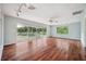 Spacious living room with hardwood floors and sliding glass doors to a balcony at 6775 Timberland Ln, Sarasota, FL 34241