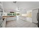 Bright kitchen with white cabinetry, stainless steel appliances and views to pool at 6775 Timberland Ln, Sarasota, FL 34241