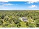 Aerial view showing house, pool, and expansive green space at 6775 Timberland Ln, Sarasota, FL 34241