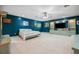 Large main bedroom with teal walls, a built-in entertainment center, and carpet flooring at 6775 Timberland Ln, Sarasota, FL 34241