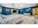 Main bedroom with teal walls and a built-in entertainment center at 6775 Timberland Ln, Sarasota, FL 34241