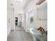Bathroom with glass vanity, tiled floors, and a large mirror at 6775 Timberland Ln, Sarasota, FL 34241