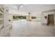 Large living area with tile floors, fireplace, built-in shelving and pool view at 6775 Timberland Ln, Sarasota, FL 34241