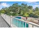 Kidney-shaped pool surrounded by a brick patio and lush landscaping at 6775 Timberland Ln, Sarasota, FL 34241
