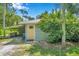 House exterior showcasing a yellow door and lush landscaping at 6775 Timberland Ln, Sarasota, FL 34241