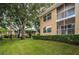 Two-story building with balconies, surrounded by green landscaping at 2156 Masters Ct # 2156, Dunedin, FL 34698