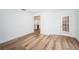 Open living room with wood-look floors and access to patio at 2156 Masters Ct # 2156, Dunedin, FL 34698