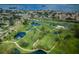 Aerial view of community, showing lush green landscape, ponds, and nearby waterfront at 2156 Masters Ct # 2156, Dunedin, FL 34698