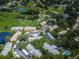 Aerial view of community with buildings, lush landscaping, and a pool at 2156 Masters Ct # 2156, Dunedin, FL 34698